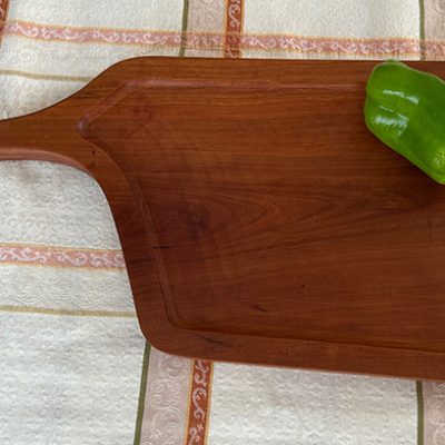 Cherry wood board with green pepper